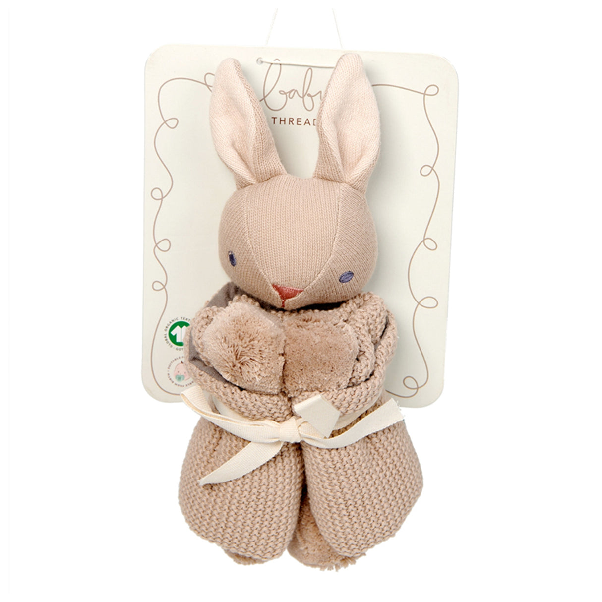 Beige knitted bunny with pom-poms on a white background