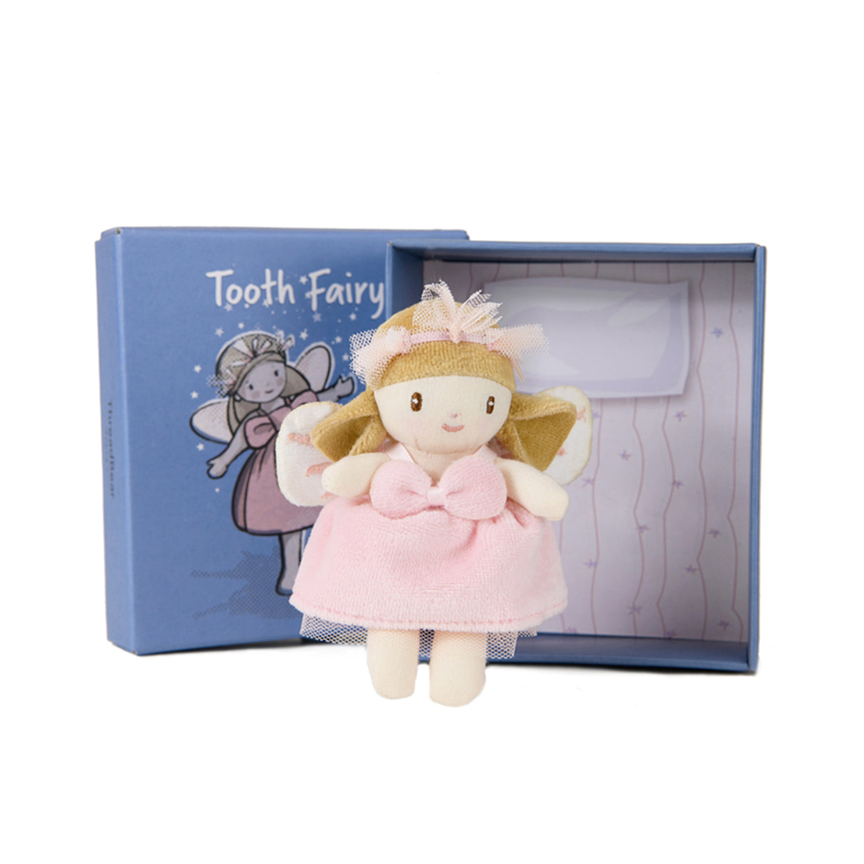 A plush toy designed like the tooth fairy, with a pink dress and embroidered wings, displayed in an open blue box with a illustration of the tooth fairy on the cover.