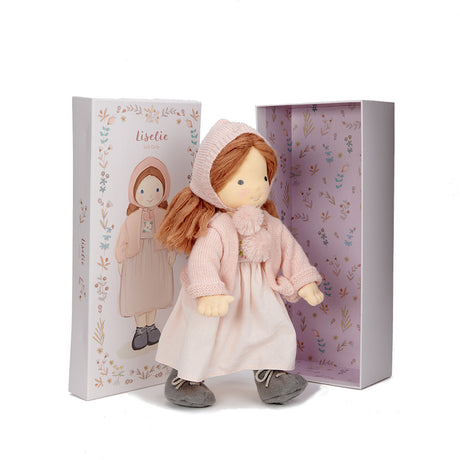 Waldorf style Doll wearing a pink coat, bonnet and dress with a matching gift box with floral patter on a white background