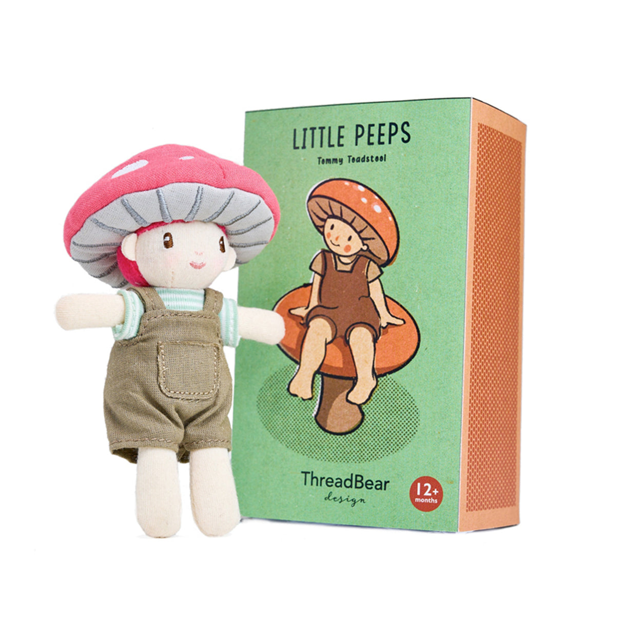 Toy mushroom character with overalls next to its packaging on a white background