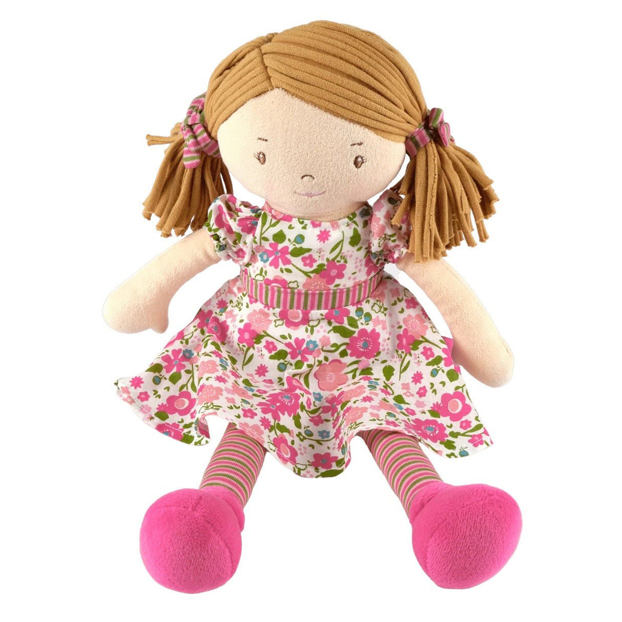 Soft rag doll with pigtails wearing a pink and green floral dress and matching tights and hair ties sitting down