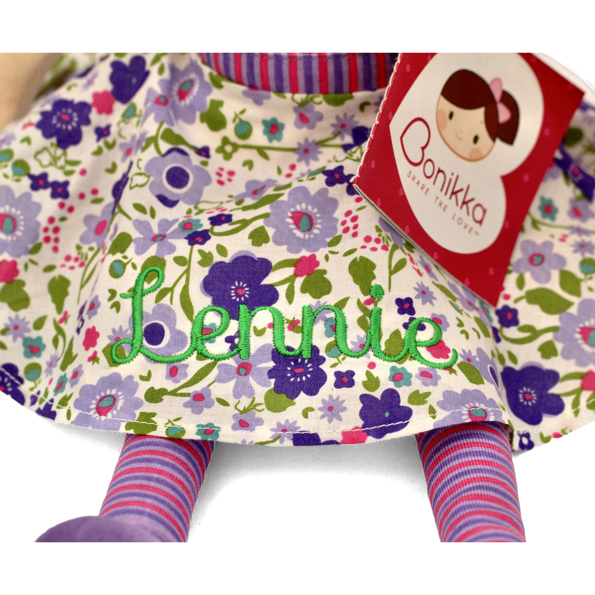 Floral-patterned doll with a personalised name embroidered on it and a Bonikka label.