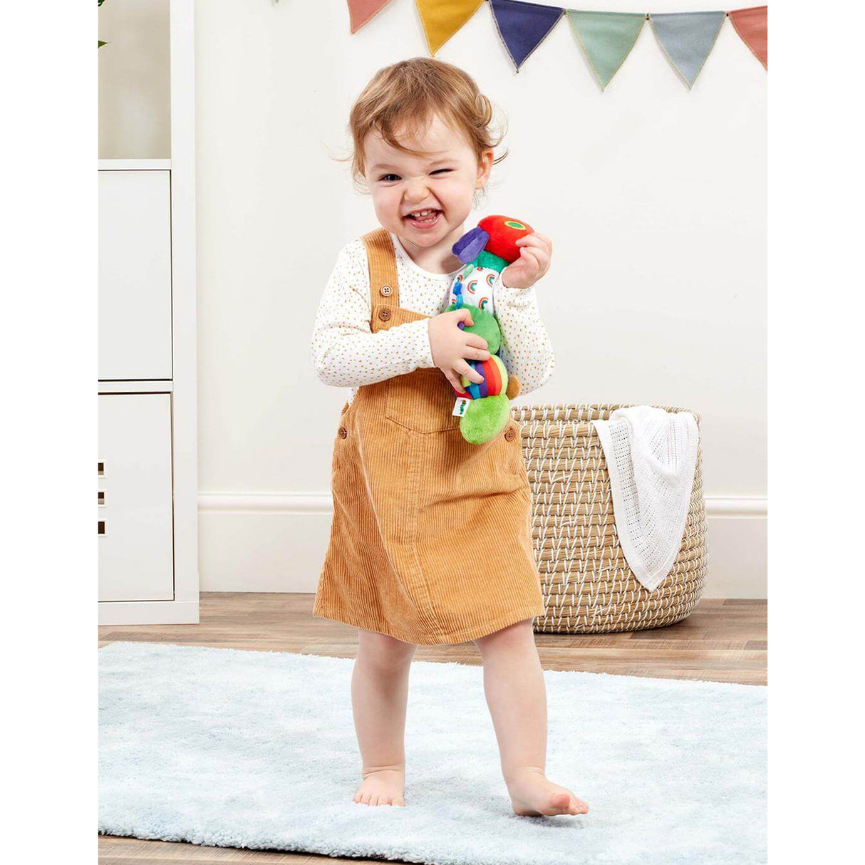 Child holding hungry caterpillar toy
