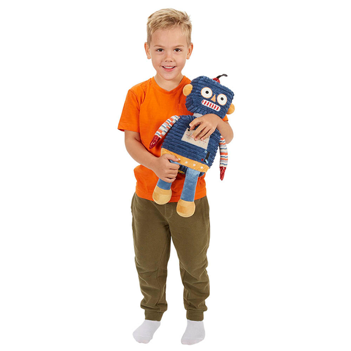 child in orange top holding a dark blue robot toy with a striped shirt and brown feet, made of soft textiles.