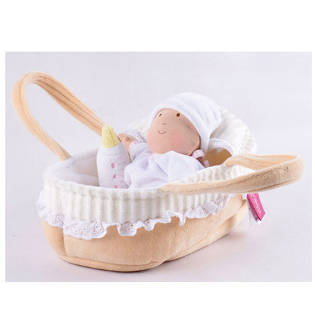 Side view of a personalised Bonikka rag doll baby in a cot with large carrying loops.