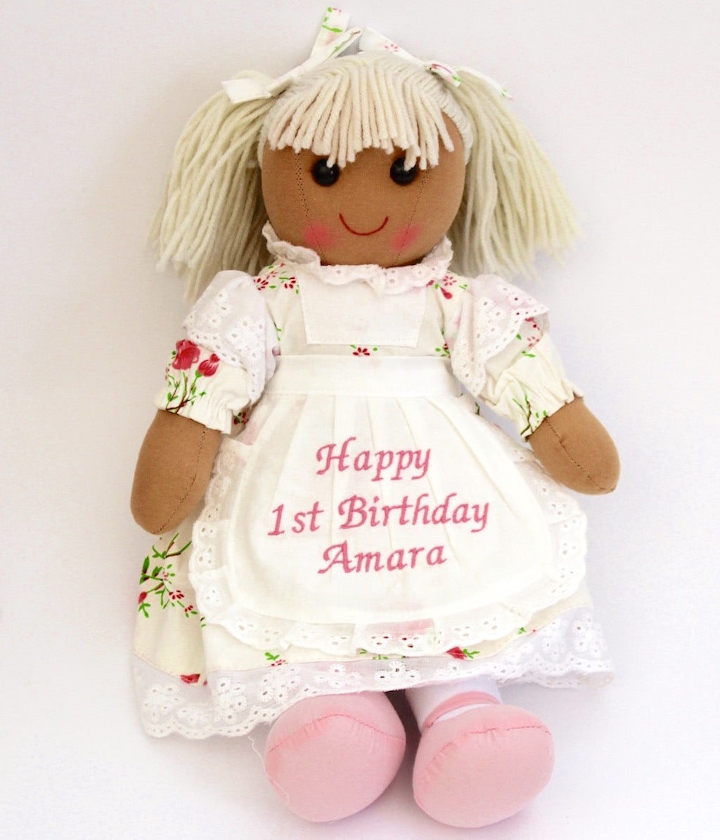 Powell Craft Rag Doll Rose Floral at 40cm tall, rosy cheeks, a happy smiling face and wearing a personalised apron