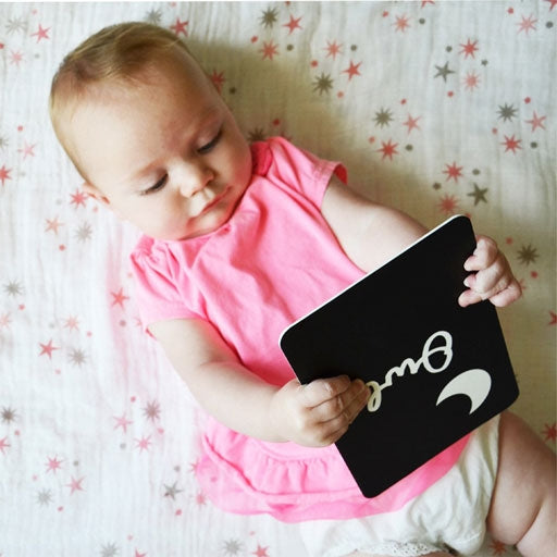 Beautiful Baby holding Wee Gallery boxed set which includes a Fish, Jellyfish, Octopus, Sea Horse, Stingray and Turtle