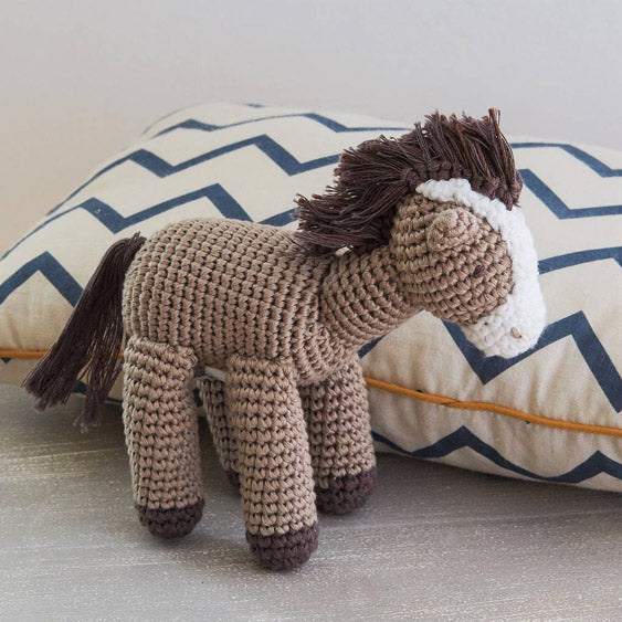 Albetta Crochet Horse Soft Toy by a cushion
