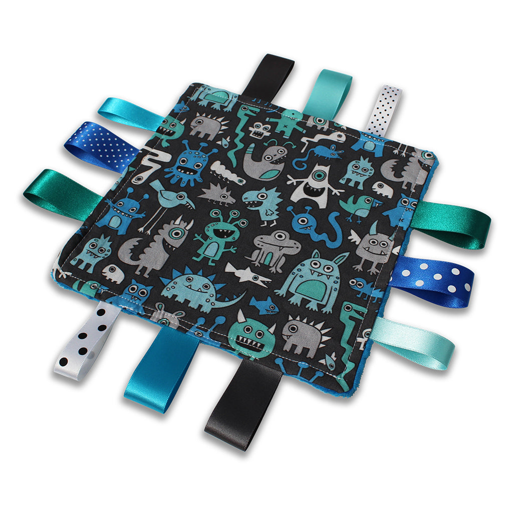 A lovely unique handmade Baby Taggy comforter Professionally made using adorable 'Monsters' fabric
