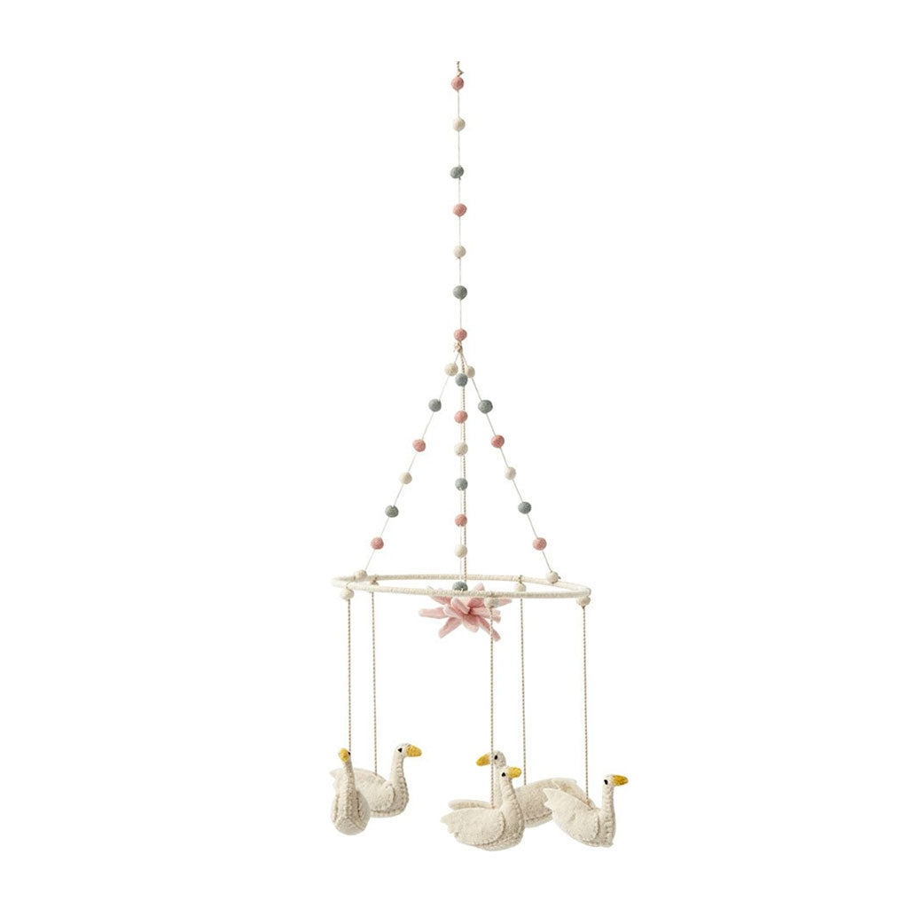 Petit Pehr mobile has five swans hanging above and a pink lily in the centre