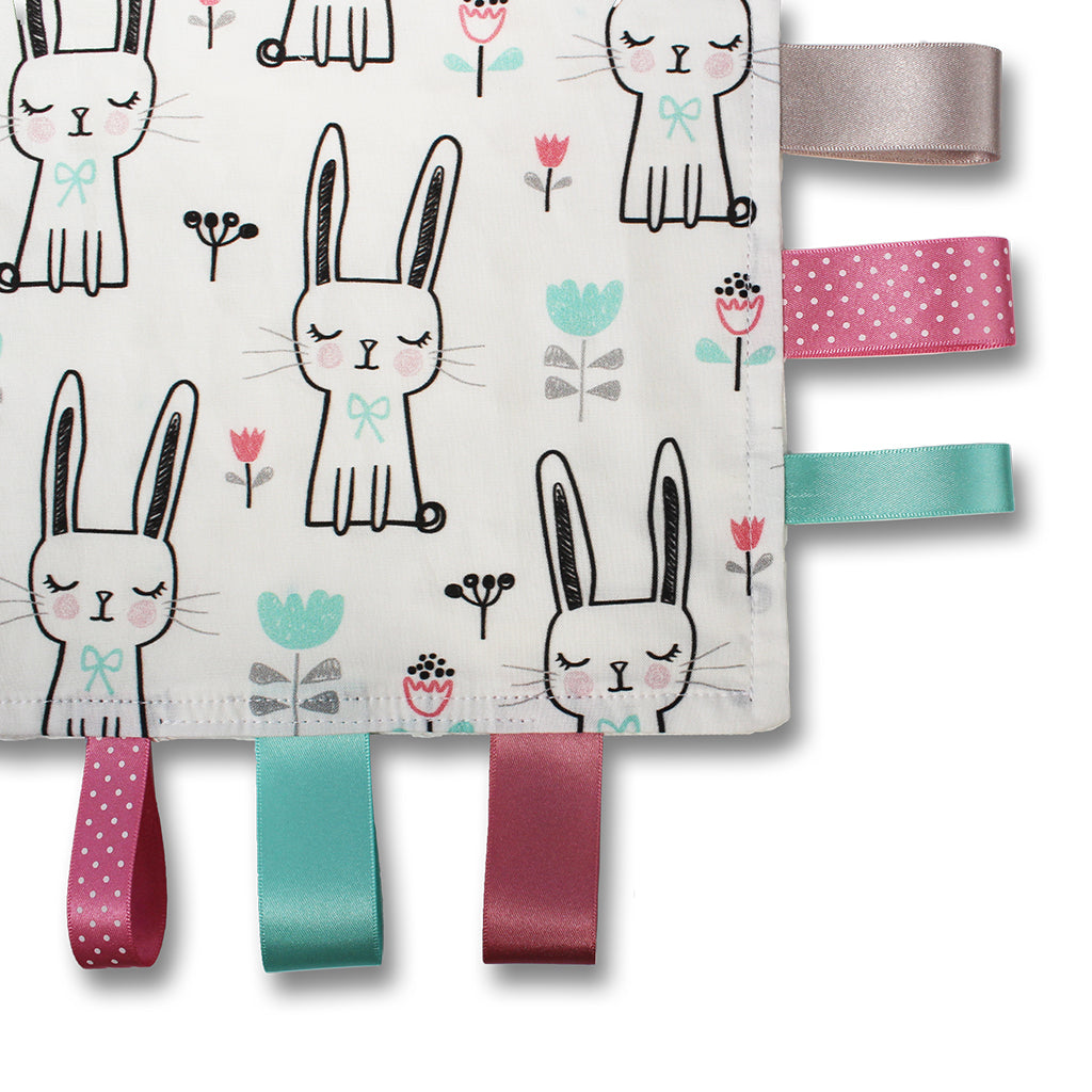 Close up view of a lovely unique handmade Baby Taggy comforter which can be personalised. 100% soft cotton, printed using an eco-friendly process