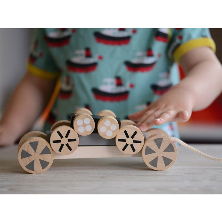 Plan Toys three rolling stacking cars with graphically wheels that stack in different ways