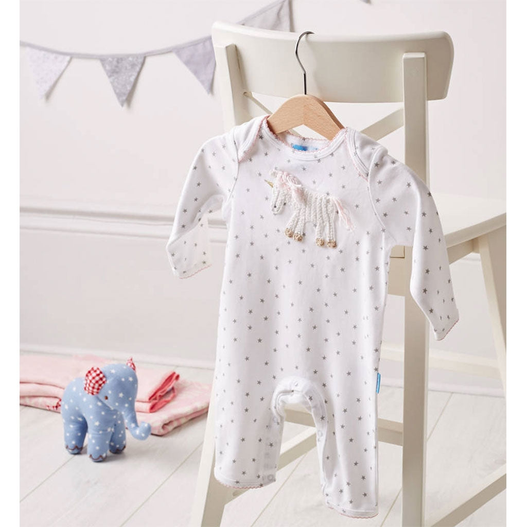 Albetta babygrow with a beautiful hand crocheted unicorn - would make the perfect baby gift for a little girl. hanging up on a chair