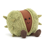 A plush toy resembling a conker, with a soft green shell and a brown body, sitting upright with a happy expression.