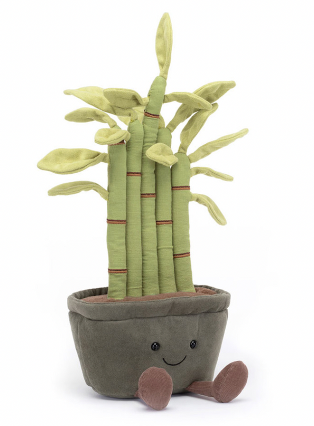 A plush toy resembling a potted bamboo plant with green leaves, red-brown stitch details, and a gray pot. The toy has a cheerful expression and fluffy soil at the bottom.