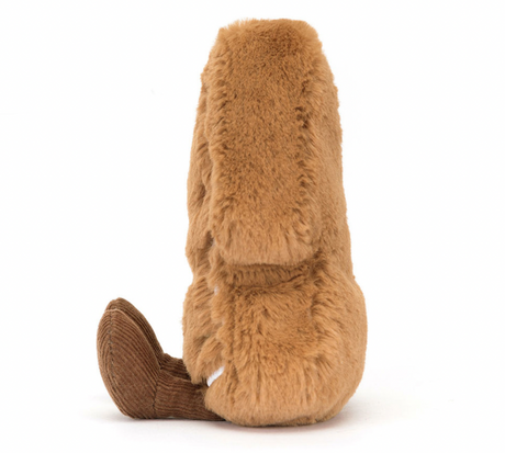 A plush toy resembling a Christmas tree cookie with brown fur, and brown cord boots.