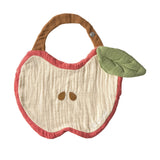 Oli & Carol Pepa The Apple Bib in organic cotton muslin, apple-shaped with red border, cream centre, embroidered seeds and green leaf detail, on a white background