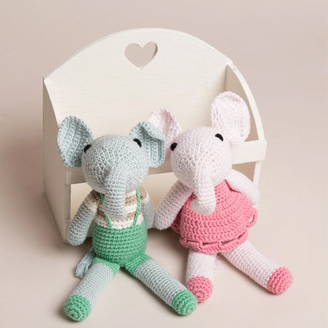 Hand crocheted pink and green elephant toys made from organic bamboo and cotton yarn, designed with big ears and a small tail.