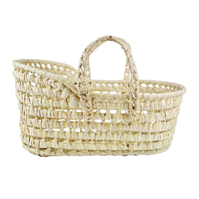 A beige wicker  woven bassinet or moses basket with two side handles, suitable for carrying dolls or soft toys.