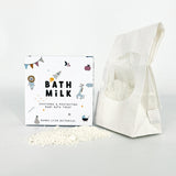 Bath milk packaging with a white bag of bath milk on a light gray background