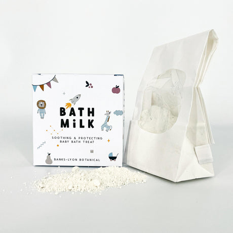 Bath milk packaging with a white bag of bath milk on a light gray background