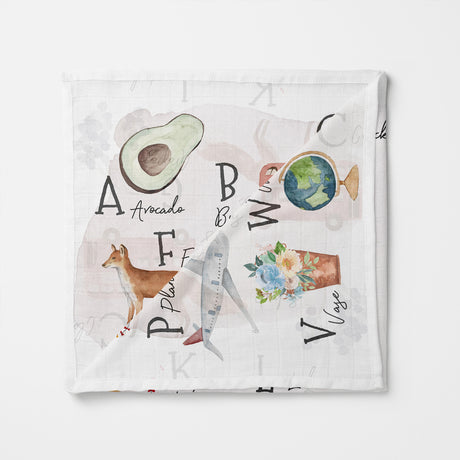 Baby swaddle with alphabet and nature-themed illustrations on a white background