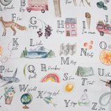 Alphabet-themed swaddle with illustrations and text on a white background