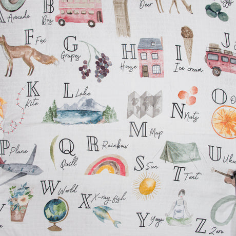 Alphabet-themed swaddle with illustrations and text on a white background