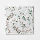 Folded swaddle  with leaf pattern on a white background