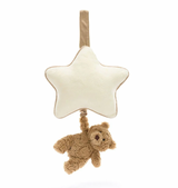 A beige and brown Jellycat musical pull toy in the shape of a star with a small bear hanging from it.