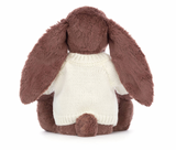 A brown bunny plush toy with long ears, wearing a white knitted jumper