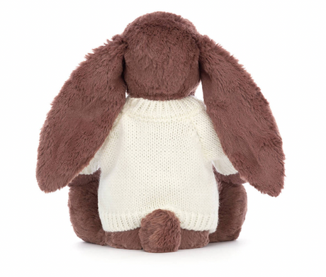 A brown bunny plush toy with long ears, wearing a white knitted jumper