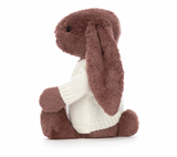 A brown bunny plush toy with long ears, wearing a white knitted jumper