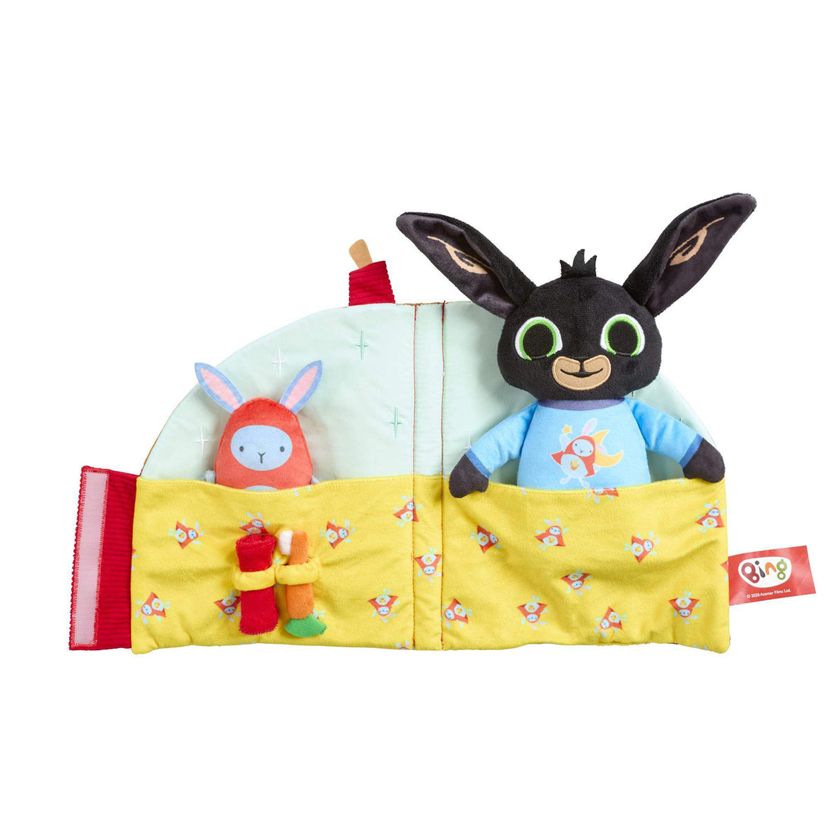 A folded out sleep toy featuring a black bunny character in a blue shirt peeking out from a yellow bed, alongside a red bunny figure.
