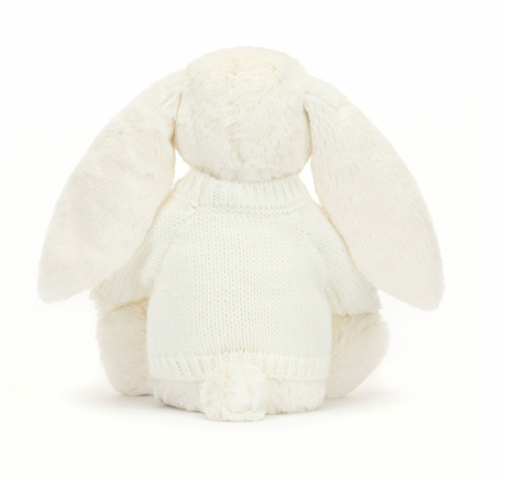 white Soft bunny toy wearing a knitted white jumper