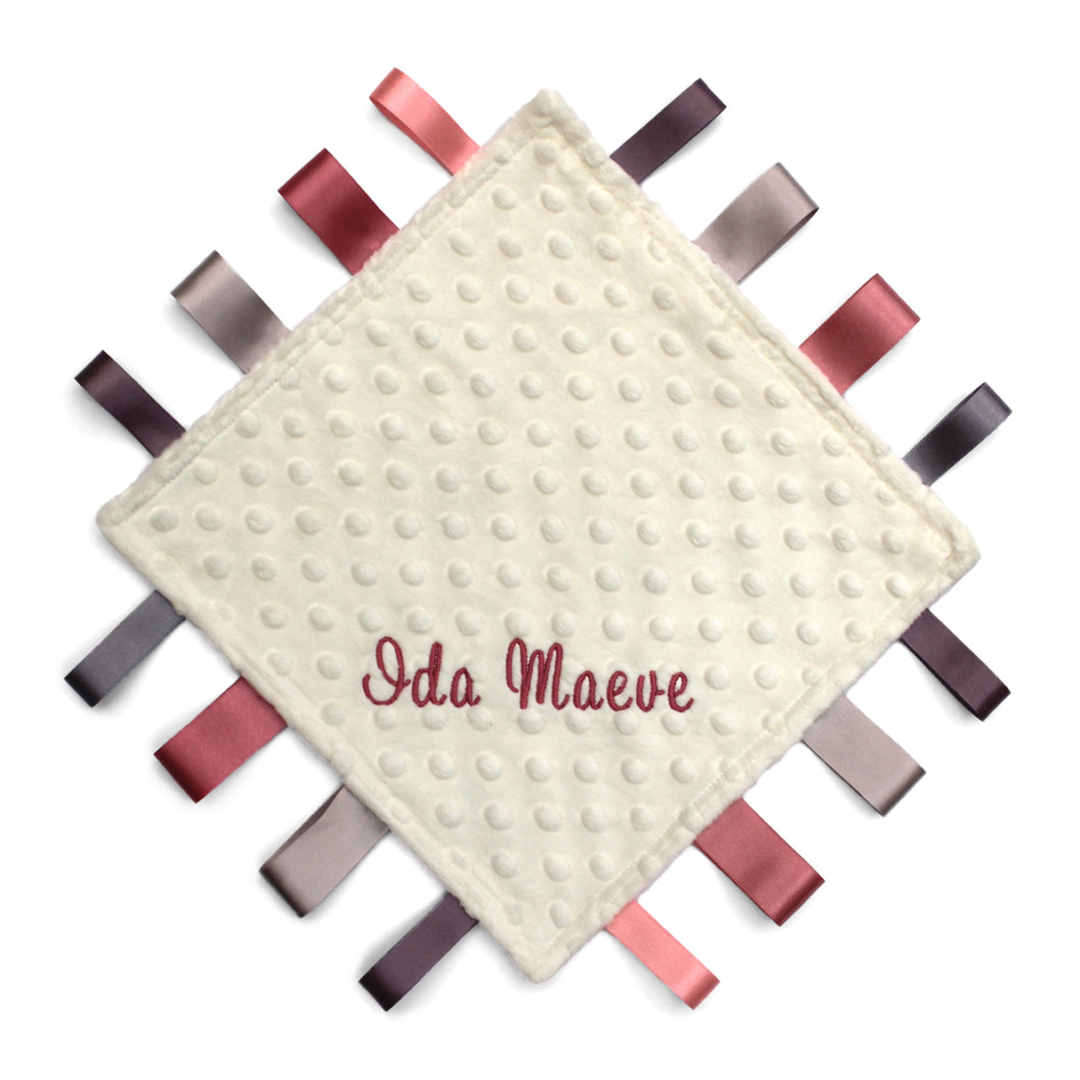 Baby comfort blanket with textured surface and colorful ribbons around the edge, featuring the name 'Ida Maeve'.