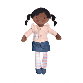 Rag doll with black skin and hair in pigtails, wearing a pink shirt, blue skirt, and striped socks on a white background.