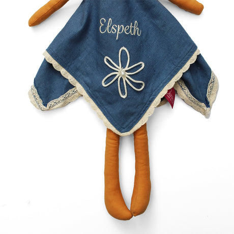 Blue dress with cream flower and embroidered name on a white background