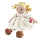 Stuffed doll with blonde hair, white dress, and brown shoes on a white background