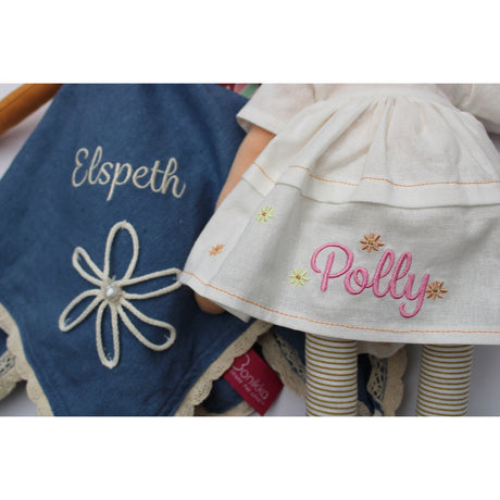 Dolls dresses with embroidered names personalised them