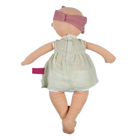 Baby doll with a green dress and pink headband on a white background