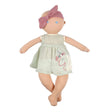 Soft rag doll with a green dress and pink headband on a white background