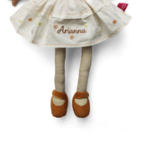Plush soft rag doll with name personalised on the cream dress which has brown and yellow flowers. The doll also has brown and cream stripey tights and brown shoes on a white background