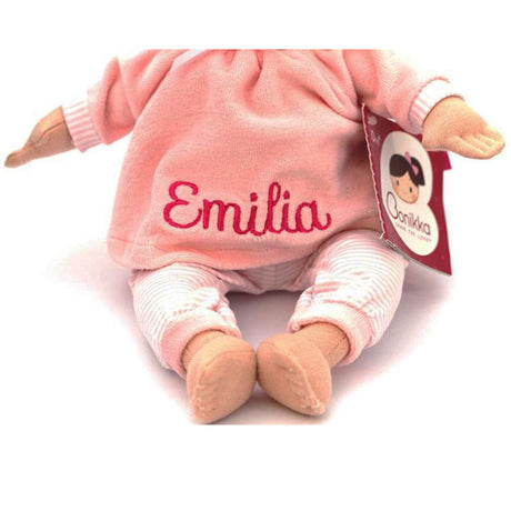 Plush doll in pink outfit with 'Emilia' embroidered on it, on a white background