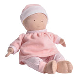 Baby doll in pink outfit with a white hat on a white background