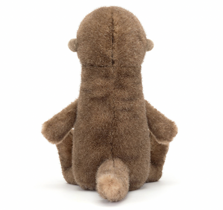 A plush toy depicting a brown otter with a soft, mottled fudge fur texture, butterscotch ears, a black nose, and bright black eyes. It is seated with a long, chunky tail extended.