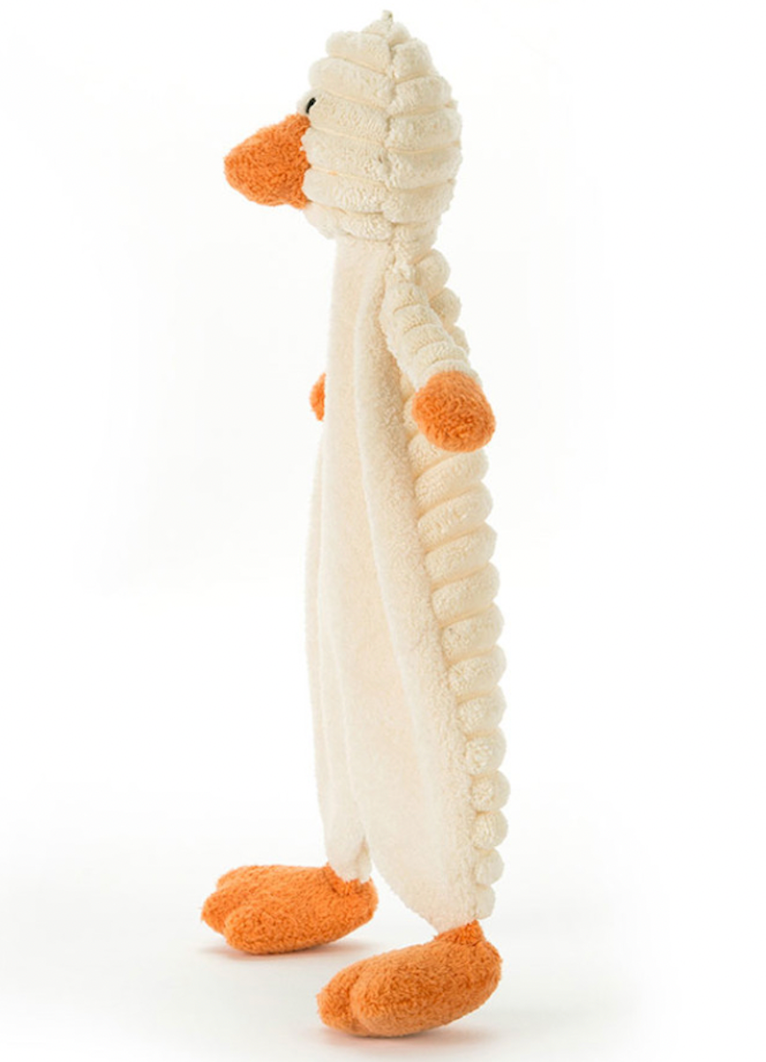 A plush toy resembling a beige and white baby duckling with orange feet and a soft, textured body.