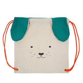 A beige cotton canvas backpack with a dog design, featuring green ears, a smiling face, and bright orange straps.