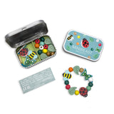 Minibeast bracelet kit with colourful beads and a tin on a white background