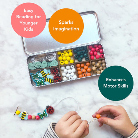 Colourful bead set in a tin with beads and tools, child's hands beading, on a light background.